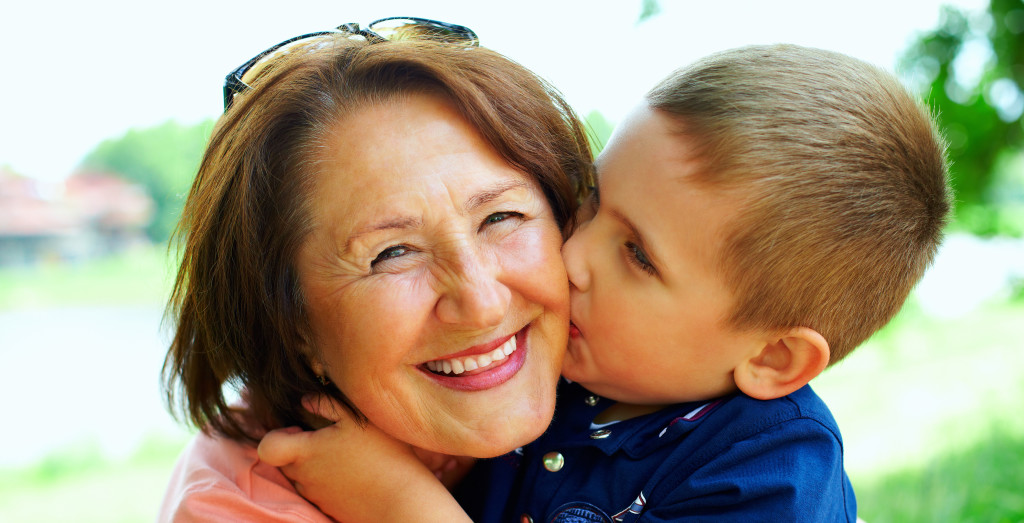 happy grandma with grandson embracing outdoor